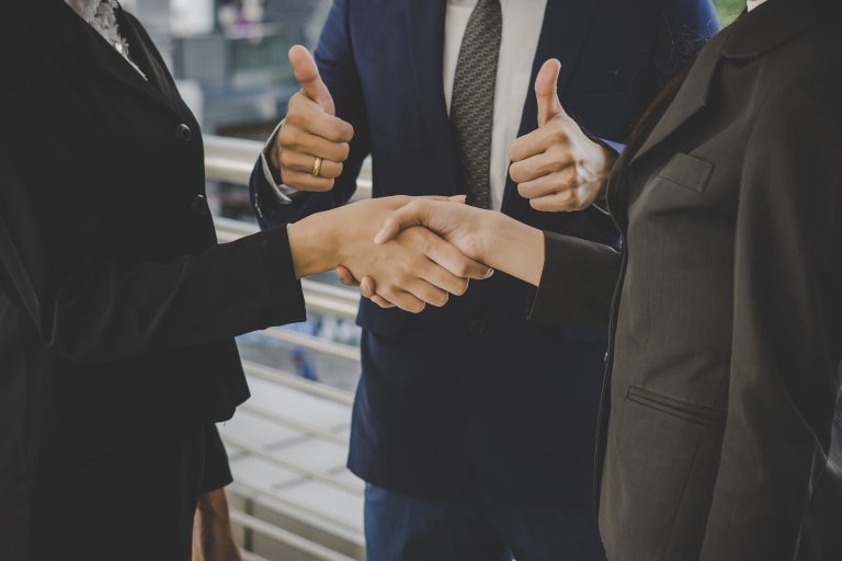 Business people shaking hands, finishing up meeting deals